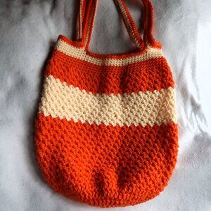 Orange and cream colored crocheted handbag